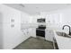 Modern kitchen with white cabinets, stainless steel appliances, and sleek countertops at 2449 Jungle St, Lakeland, FL 33801