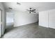 Open-concept living space featuring tile floors, modern ceiling fan, and neutral walls for versatile decorating at 2449 Jungle St, Lakeland, FL 33801