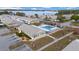 Aerial view of community pool, lake, and buildings at 260 Winter Ridge Blvd # 38, Winter Haven, FL 33881