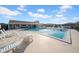 Community pool with lounge seating and shade at 260 Winter Ridge Blvd # 38, Winter Haven, FL 33881