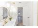 White bathroom with double vanity and access to bedroom at 817 Helen Ave, Deland, FL 32720