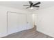 Simple bedroom with double doors leading to the closet and hardwood floors at 817 Helen Ave, Deland, FL 32720