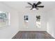 Bright bedroom with ceiling fan, wood-look floors, and large windows at 817 Helen Ave, Deland, FL 32720