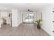 Bright dining room with sliding glass doors leading to a sunroom and hardwood floors at 817 Helen Ave, Deland, FL 32720