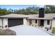 Modern home exterior with a black garage door and well-manicured landscaping at 817 Helen Ave, Deland, FL 32720