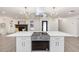 Modern kitchen island with stainless steel appliances and white cabinets at 817 Helen Ave, Deland, FL 32720