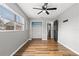 Bright bedroom featuring hardwood floors, ceiling fan and window looking out to backyard at 156 Whitman Rd, Winter Haven, FL 33884