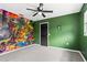 bedroom with green walls and a large dinosaur mural at 156 Whitman Rd, Winter Haven, FL 33884