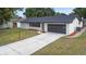 Newly renovated home with a gray garage door and landscaping at 156 Whitman Rd, Winter Haven, FL 33884