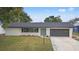 Ranch style home with gray garage and newly landscaped yard at 156 Whitman Rd, Winter Haven, FL 33884