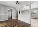 Bright hallway with hardwood floors and access to kitchen at 156 Whitman Rd, Winter Haven, FL 33884