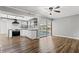 Living room features hardwood floors, ceiling fan, and sliding doors to the pool at 156 Whitman Rd, Winter Haven, FL 33884