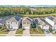 Two-story home with well-maintained landscaping, pond view, and a two-car garage in a Gathering neighborhood at 163 Tiny Flower Rd, Davenport, FL 33837