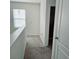 Upstairs hallway with carpet and doors to bedrooms at 163 Tiny Flower Rd, Davenport, FL 33837