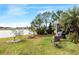 Landscaped backyard with lake view, firepit and patio at 3782 Hampton Hills Dr, Lakeland, FL 33810