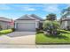 One-story house with gray siding, two-car garage, and landscaped lawn at 3782 Hampton Hills Dr, Lakeland, FL 33810