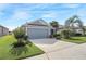 House exterior with gray siding, two-car garage, and well-manicured lawn at 3782 Hampton Hills Dr, Lakeland, FL 33810