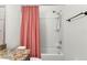 Bathroom with tub, shower, and coral shower curtain at 1066 Krenson Woods Rd, Lakeland, FL 33813