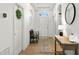 Bright entryway with tile floors, bench, and wooden console table at 1066 Krenson Woods Rd, Lakeland, FL 33813