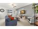 Living room with gray walls, comfy couch, and sliding glass doors at 1066 Krenson Woods Rd, Lakeland, FL 33813