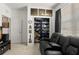 Home office with built-in shelving and black couch at 1066 Krenson Woods Rd, Lakeland, FL 33813