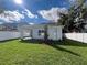 Green backyard with a white privacy fence with partial views of the home at 1701 Ferris Ave, Orlando, FL 32803