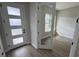 Inviting home entryway features a modern frosted glass front door and beautiful light-colored laminate flooring at 1701 Ferris Ave, Orlando, FL 32803