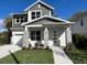 Charming two-story home with a well-manicured lawn, inviting entryway, and a classic architectural design at 1701 Ferris Ave, Orlando, FL 32803