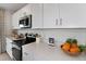 White kitchen with stainless steel appliances and quartz countertops at 1924 Rosewood Cir, Lakeland, FL 33810