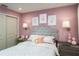 Charming bedroom with a gray headboard and pink walls at 1944 Rosewood Cir, Lakeland, FL 33810