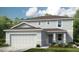 Two-story house with gray siding, brown roof, and a two-car garage at 1944 Rosewood Cir, Lakeland, FL 33810