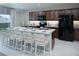 Kitchen with island, dark cabinets, and stainless steel appliances at 1944 Rosewood Cir, Lakeland, FL 33810