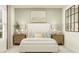 Bright bedroom with a white bed, wooden nightstands and neutral tones at 1994 Sarah St, Winter Haven, FL 33884