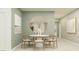 Round dining table with six chairs, light green walls, large mirror at 1994 Sarah St, Winter Haven, FL 33884