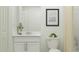 Clean bathroom with white vanity, toilet, and neutral decor at 2017 Lasso Loop, Eagle Lake, FL 33839