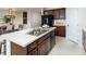 Kitchen island with double sink, granite countertop, and breakfast bar at 2018 Babbling Brook Blvd, Auburndale, FL 33823