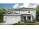 Two-story house with gray siding, three-car garage, and landscaping at 2202 Babbling Brook Blvd, Auburndale, FL 33823