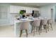 Modern kitchen island with white cabinets and quartz countertops at 2202 Babbling Brook Blvd, Auburndale, FL 33823