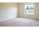 Bright bedroom with a window overlooking the backyard at 2871 Parkfield Rd, St Cloud, FL 34772