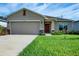 Newly built one-story house featuring a two-car garage and a neat front yard at 2871 Parkfield Rd, St Cloud, FL 34772