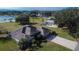 Well-maintained home showcasing mature landscaping, neutral colors, and spacious driveway at 958 Lake Deeson Pt, Lakeland, FL 33805