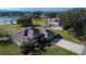 Aerial view showcasing a single-story home with a large backyard and lake access at 958 Lake Deeson Pt, Lakeland, FL 33805