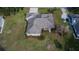 Aerial view of a landscaped property with a screened-in porch and ample lawn space at 958 Lake Deeson Pt, Lakeland, FL 33805