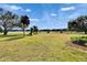 Lush backyard featuring a lake view and well-maintained lawn at 958 Lake Deeson Pt, Lakeland, FL 33805