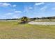 Beautiful waterfront backyard with lush green grass and private dock at 958 Lake Deeson Pt, Lakeland, FL 33805
