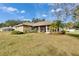 Expansive backyard featuring a screened patio and beautiful landscaping at 958 Lake Deeson Pt, Lakeland, FL 33805