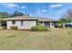 Well-maintained backyard featuring a screened porch, tidy landscaping, and lush lawn at 958 Lake Deeson Pt, Lakeland, FL 33805