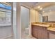 Well-lit bathroom showcasing granite countertops, dual sinks, and a separate water closet for added privacy at 958 Lake Deeson Pt, Lakeland, FL 33805