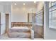 Luxurious bathroom featuring a soaking tub with decorative tile surround and a separate glass-enclosed shower at 958 Lake Deeson Pt, Lakeland, FL 33805