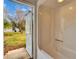Bathroom featuring tub and shower combination with door to back yard at 958 Lake Deeson Pt, Lakeland, FL 33805